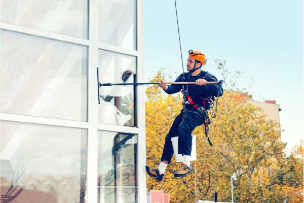 Contractors cleaning commercial glass windows